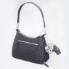 A black Hobo Concealed Carry Purse in quilted microfiber is shown with its zipper pocket partially open, revealing a silver revolver inside.